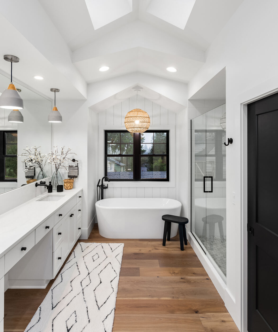 Master bath with skylight vaulted ceiling and freestanding soaking tub