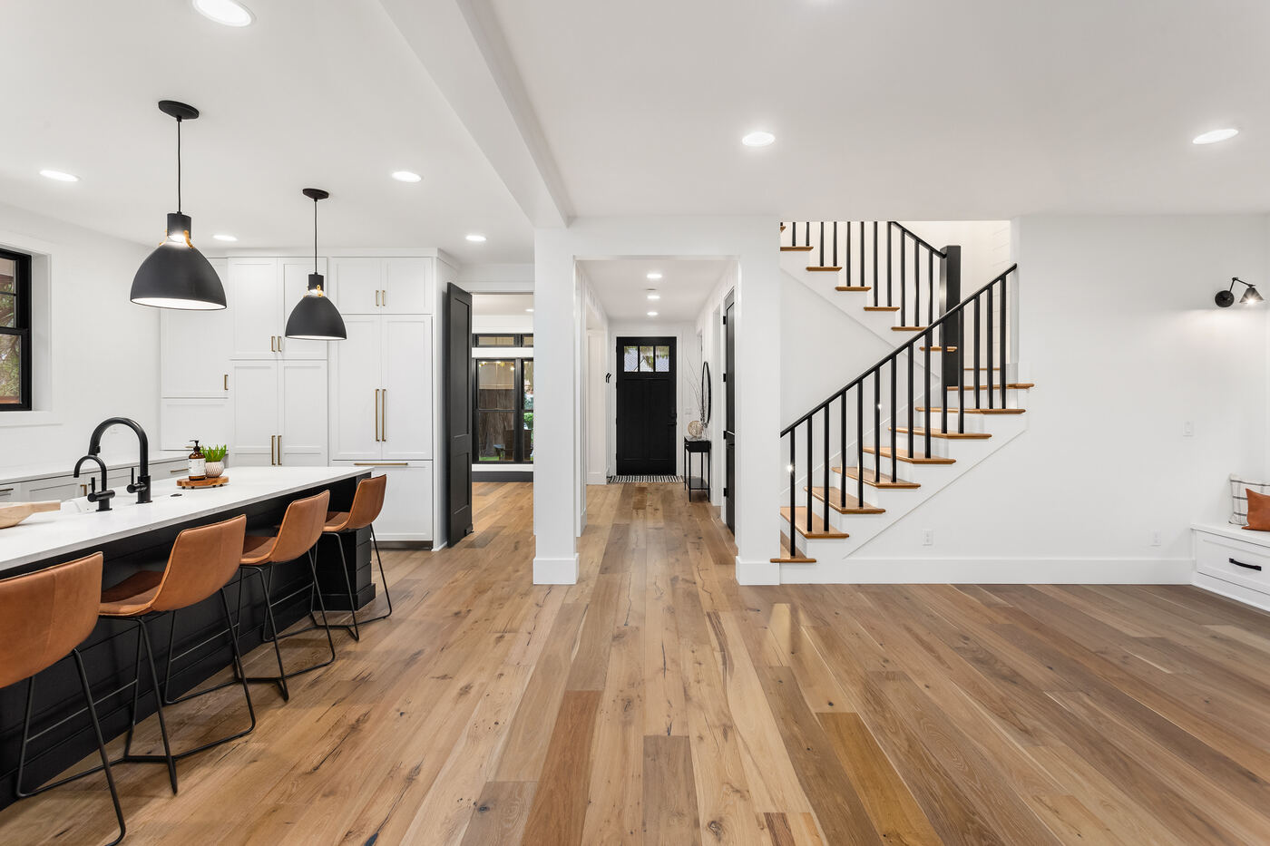 Open concept addition with staircase and wide plank hardwood